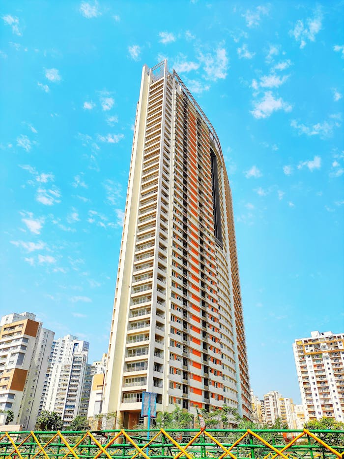 Impressive skyscraper reaching into a vibrant blue sky, showcasing modern architecture.